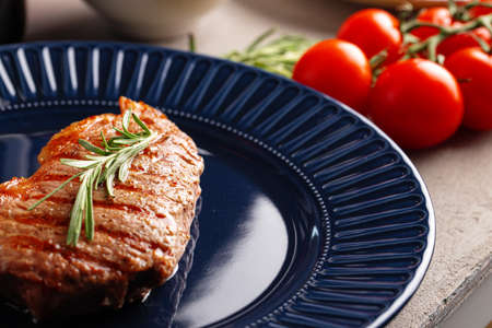 Grilled beef steak served on blue plateの写真素材