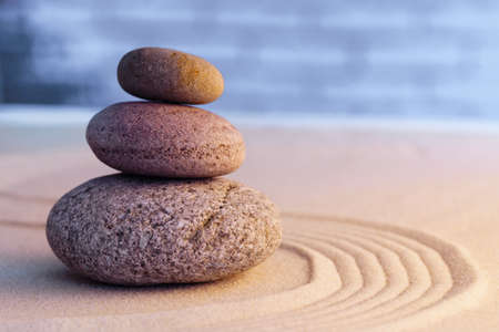 Zen garden stones on sand with ornament