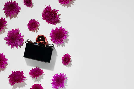 Bottle of fragrance surrounded by flower budsの写真素材