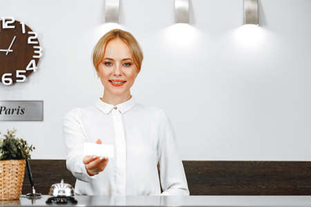 Portrait of beautiful blonde woman hotel receptionistの写真素材