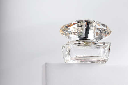 Fragrance bottle on gray block against gray backgroundの写真素材