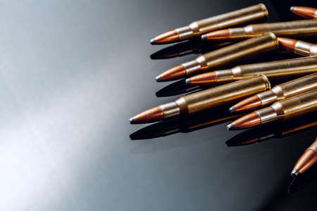 Rifle bullets or cartridges on black shiny backgroundの写真素材