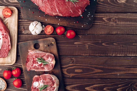 Raw meat beef shank slices on brown wooden boardの写真素材