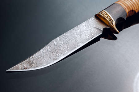 Hunting knife on black background with reflectionの写真素材