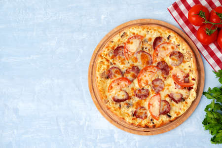 Delicious pizza with sausages on gray backgroundの写真素材