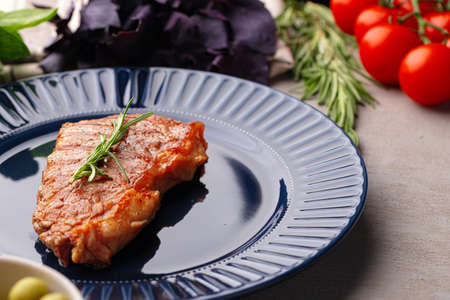 Grilled beef steak served on blue plateの写真素材