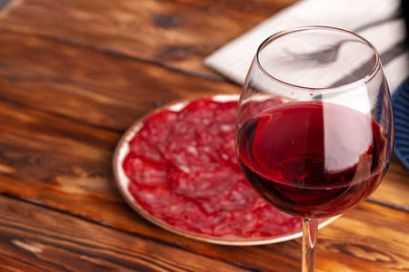 Meat slicing and wine on gray backgroundの写真素材