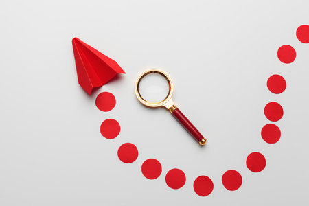 Origami toy plane of paper on white backgroundの写真素材