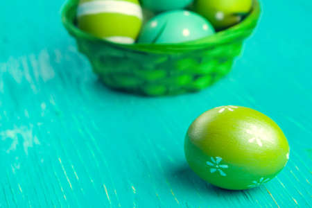 Green Easter eggs on wooden tableの写真素材