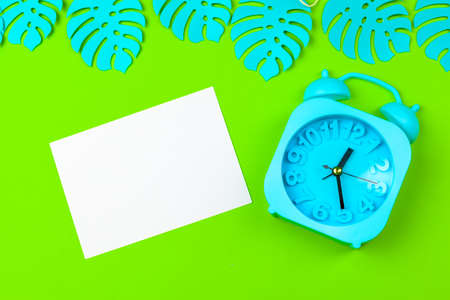 Tropical leaves with alarm clockの写真素材