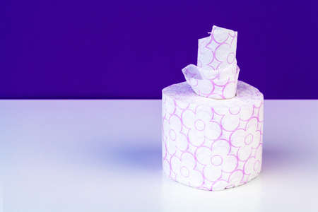 Roll of toilet paper or tissue on color backgroundの写真素材