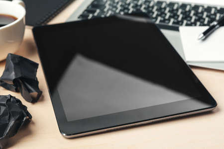 electronic gadgets and office supplies on wooden tableの写真素材