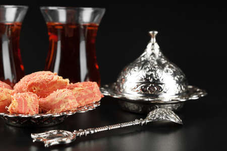 Bowl with pieces of turkish delight lokum and black tea