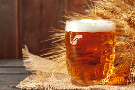 Glass beer on wood backgroundの写真素材