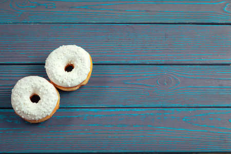 Glazed donuts on wooden backgroundの写真素材