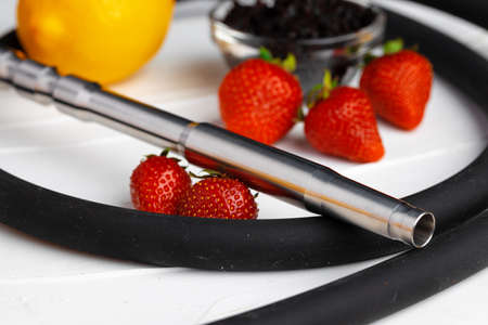 Hookah with strawberry flavour close up on dark background