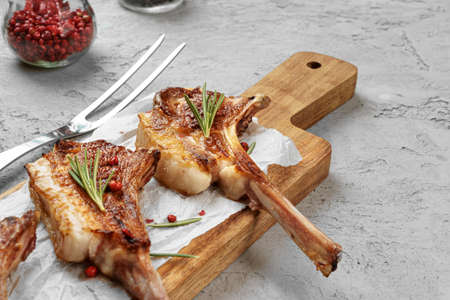 Grilled rack of lamb served on a wooden board