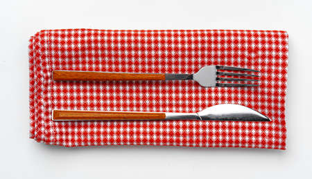 Set of fork and knife on towel. Isolated on white background.