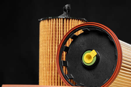 Car engine filter on dark background, close up.
