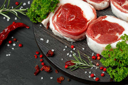 fresh meat with ingredients for cooking on dark backgroundの写真素材