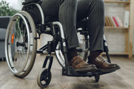 Unrecognizable man sitting in wheelchair close up