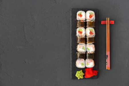 Maki sushi on black stone plate top viewの写真素材