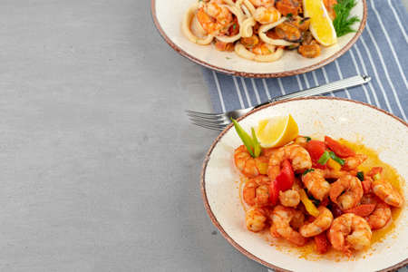 Stir fried seafood with sauce on plate with napkin