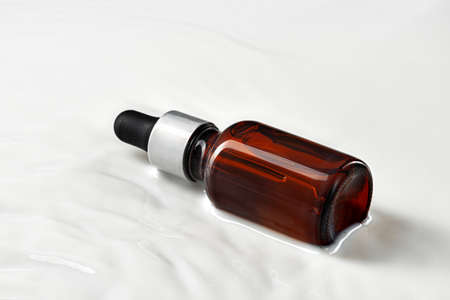 Skincare serum bottle on a light beige backgroundの写真素材