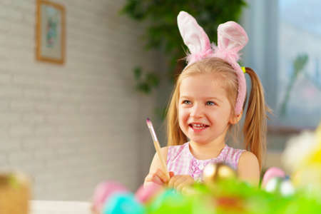 Portrait of a cute toddler girl with bunny earsの写真素材