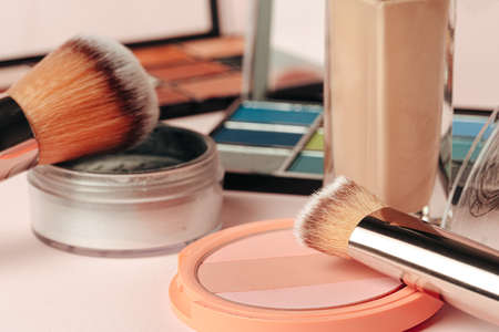 decorative cosmetics on pink background. close up