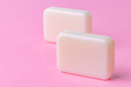 Soap bar isolated on pink background. Close up.