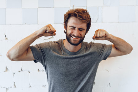Pleased joyful bearded man against rough wallの写真素材