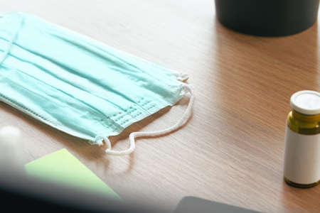 Medical protective mask on office table. Coronavirus spread prevention conceptの写真素材