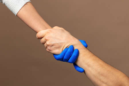 Handshake in a blue gloves, help concept. Personal hygiene during a pandemic