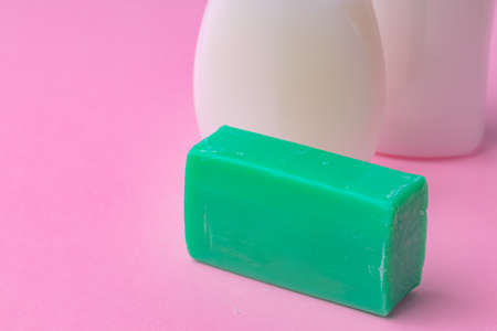 Hand antiseptic disinfection, soap bar on pink paper background.の写真素材