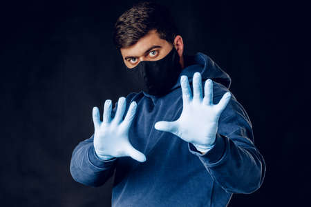 Stop world pandemia of coronavirus. Portrait of a man wearing protective maskの写真素材