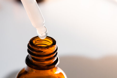 Brown glass bottles with oily skincare serum close upの写真素材