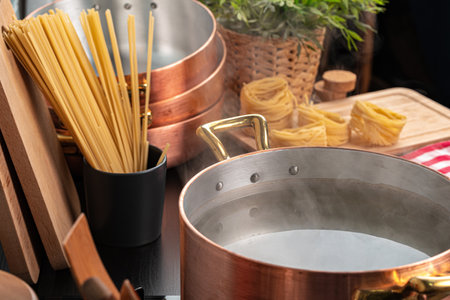 Copper pot with boiling water on a gas stove