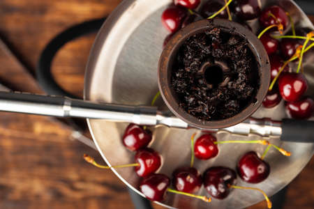 Shisha parts with fresh cherry close up