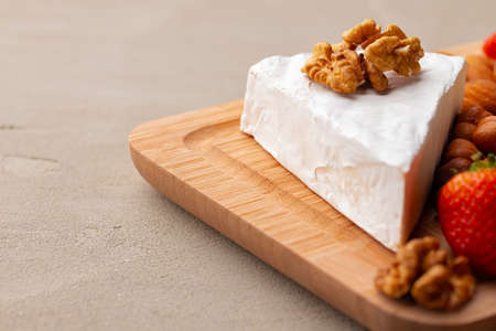 Cheese with nuts and strawberry close upの写真素材