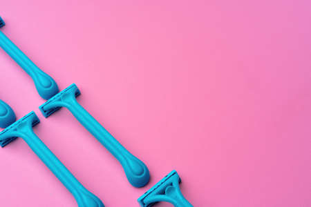 Female disposable razors on pink background top viewの写真素材