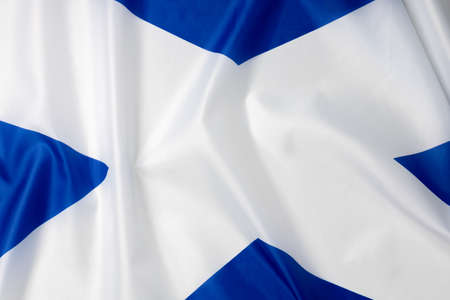 Folded national flag of Scotland, fabric background