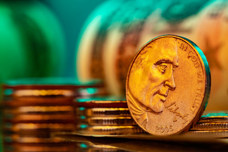 American dollar banknotes and coins on black background