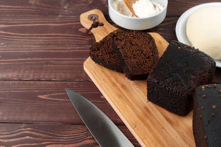 Sliced rye bread on brown wooden background