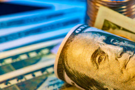 American dollar banknotes and coins on black backgroundの写真素材