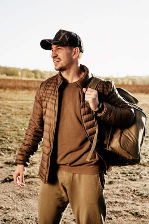 Portrait of a young man in sport trekking outfit standing