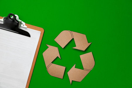 Paper recycling concept on green background top viewの写真素材