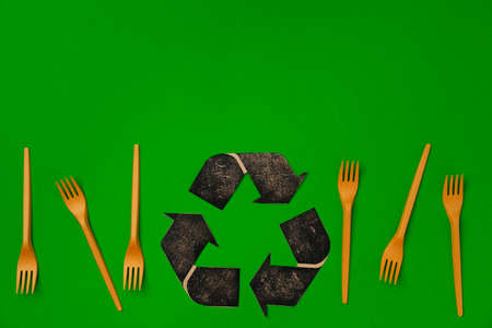Zero waste disposable tableware forks on green background