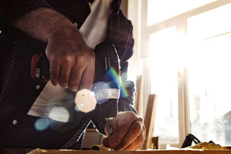 Close up of a carpenter drilling a hole in timber
