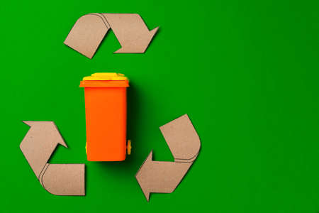 Garbage sorting concept with toy waste bin on paper background